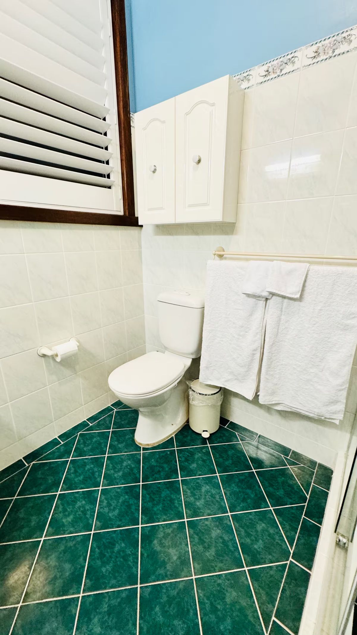 Bathroom with towel rail and fresh towels