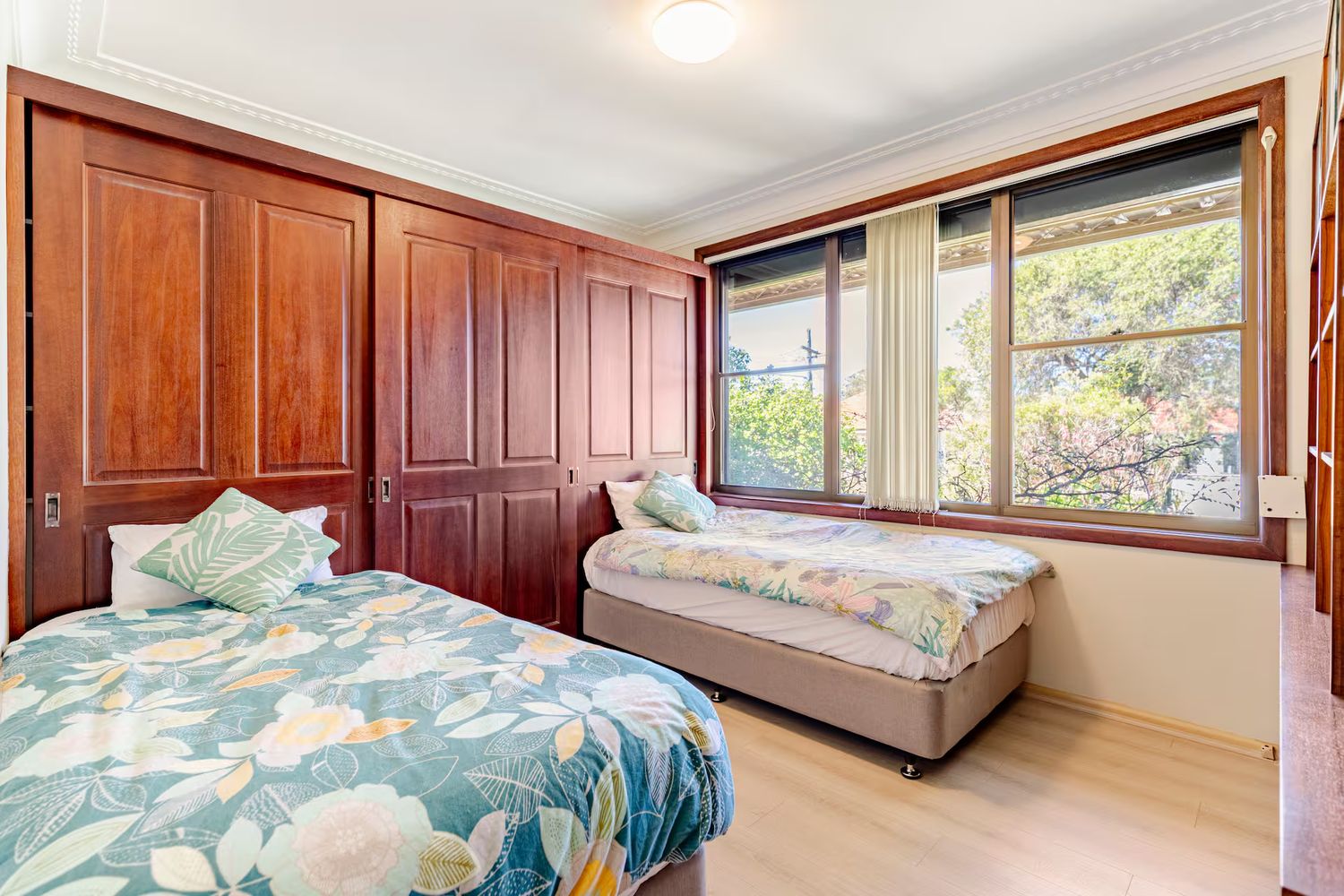 Bedroom with timber panelling and a window