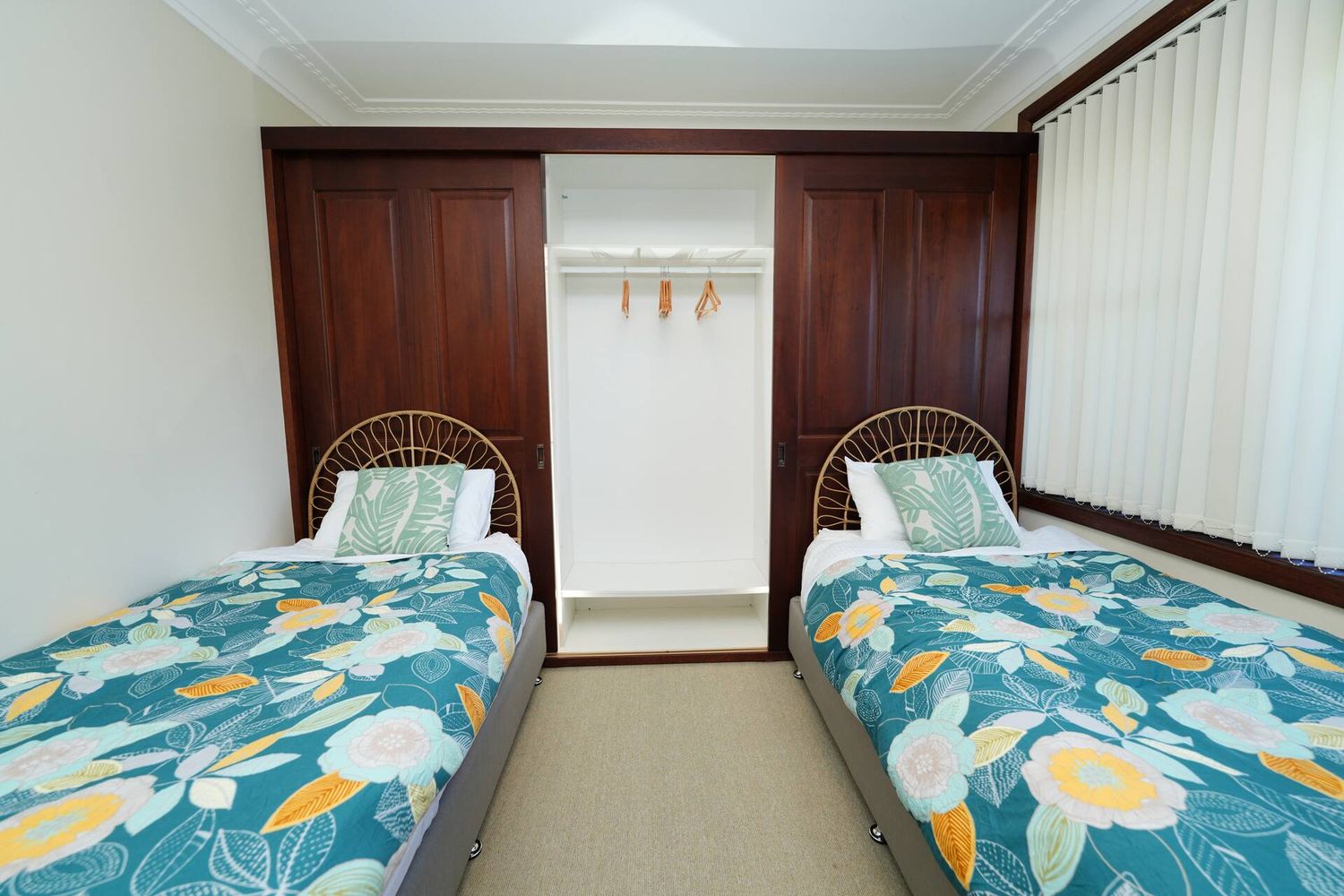 Bedroom with two king single beds either side of a wardrobe