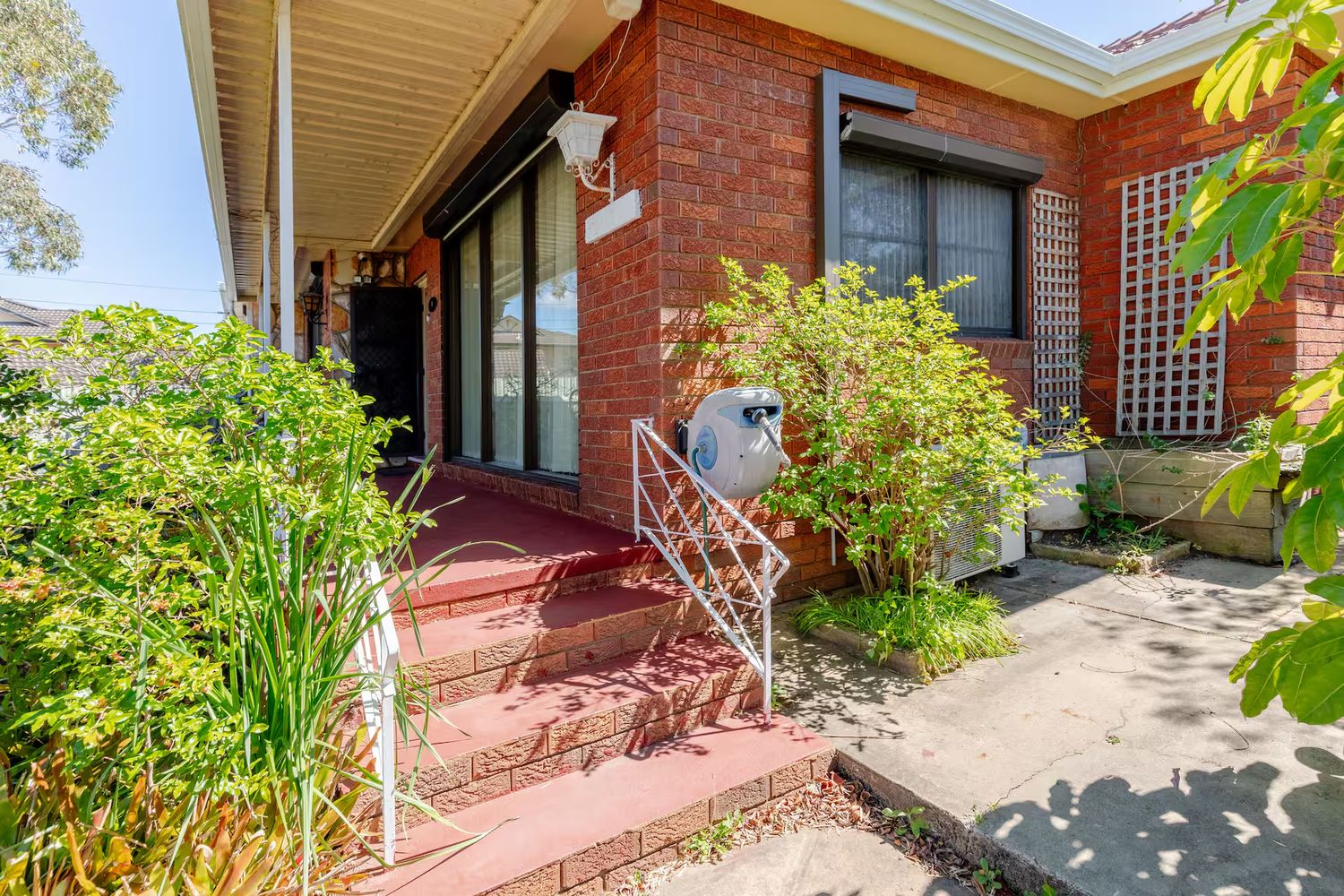Front steps with a handrail leading to the entry