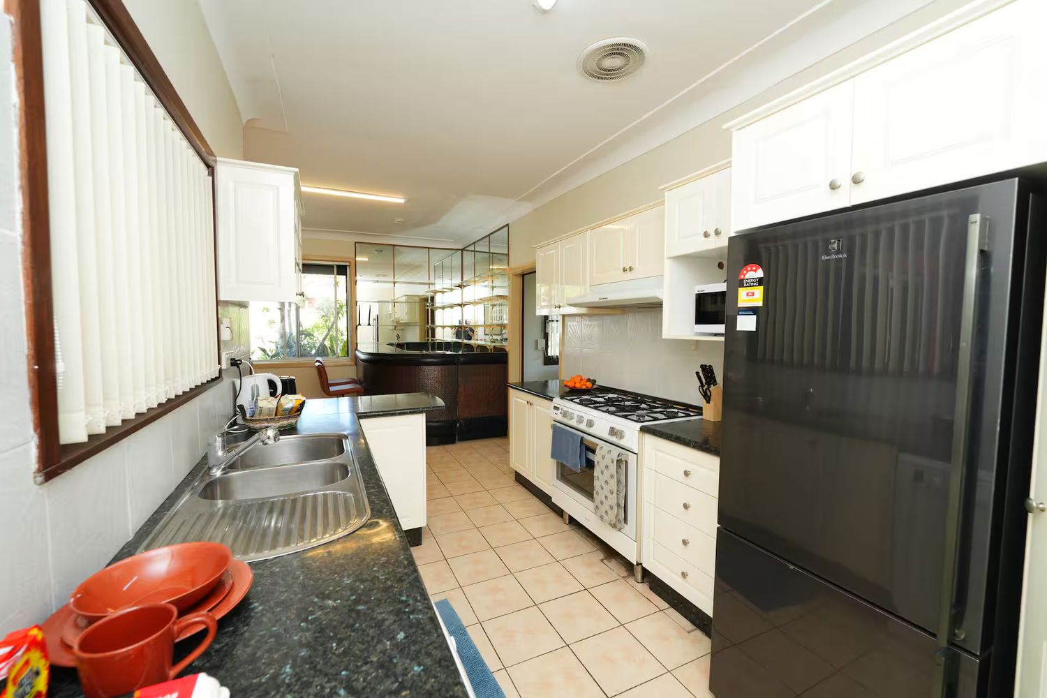 Kitchen with gas cooktop, sink and full-size fridge
