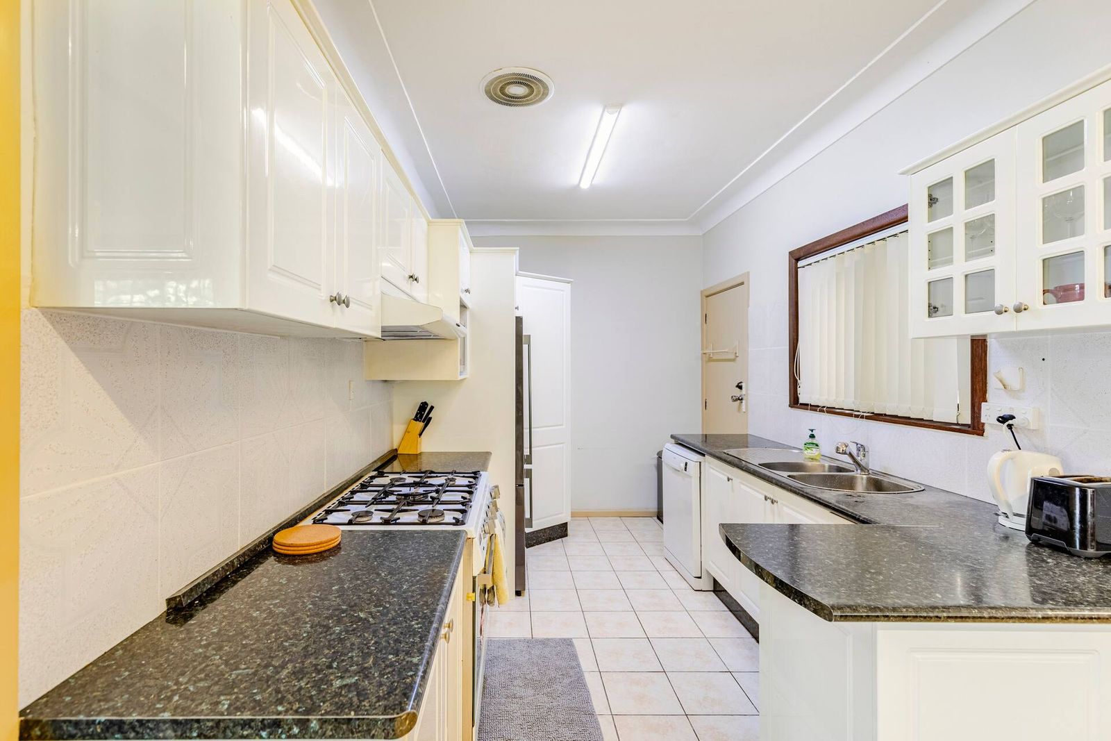 Galley kitchen with granite benchtops