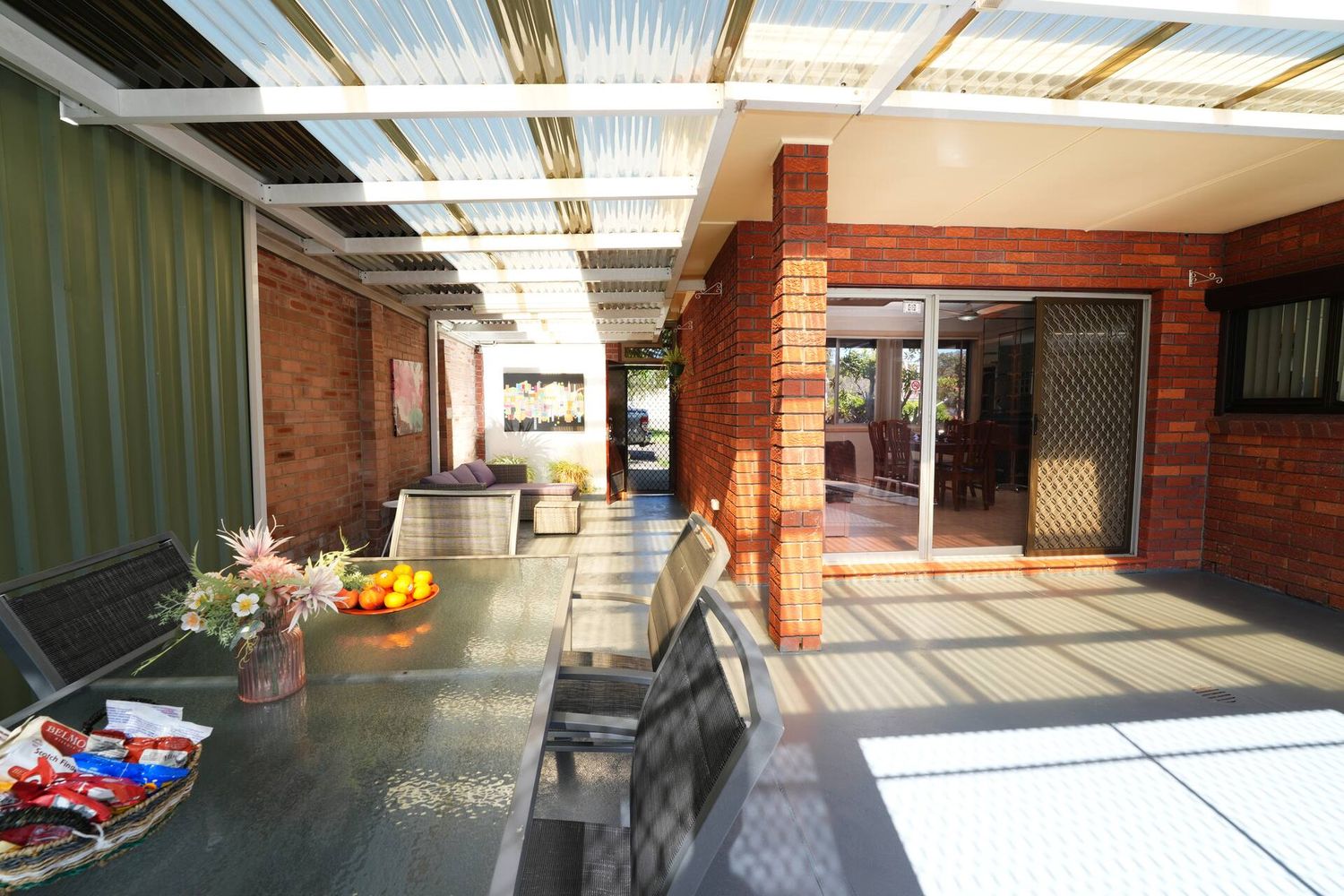 Terrace with lounge seating and doors into the dining room