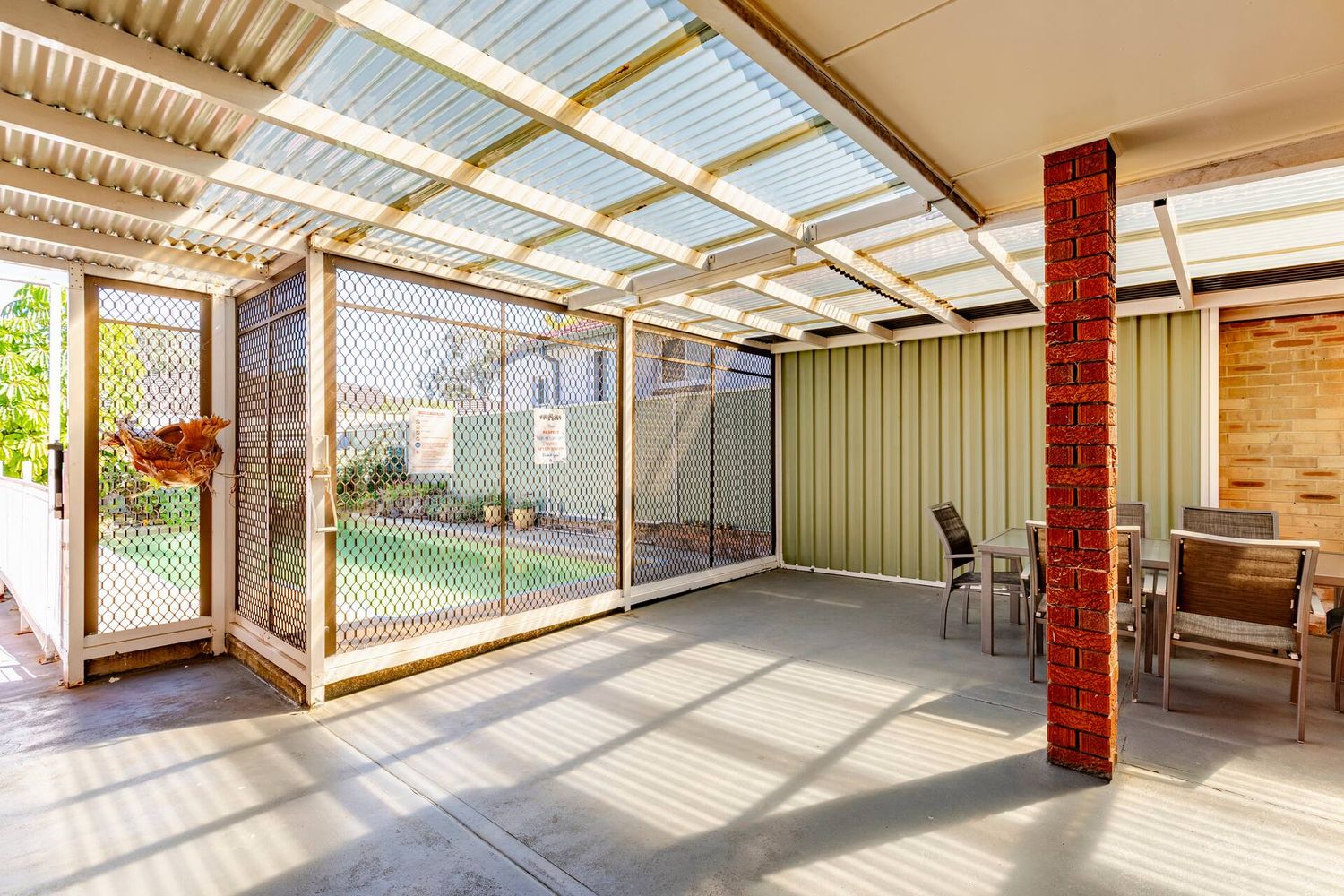 Covered terrace with the screened pool gate